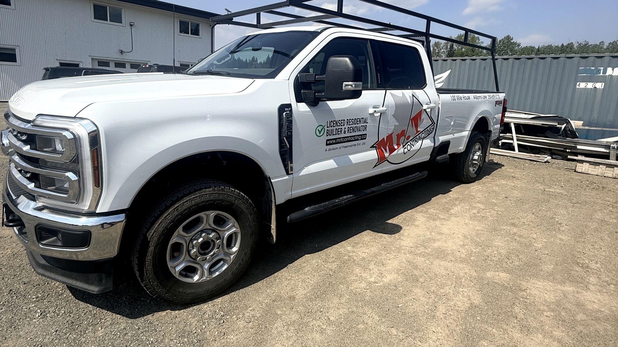 Ford Super Duty carrying Mr. T Contracting door graphics, parked in the Cariboo.