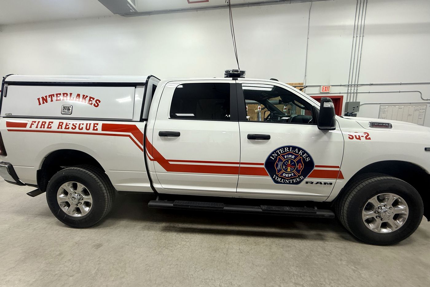 Interlakes Fire Rescue SQ-2 with red striping, department crest and unit number.