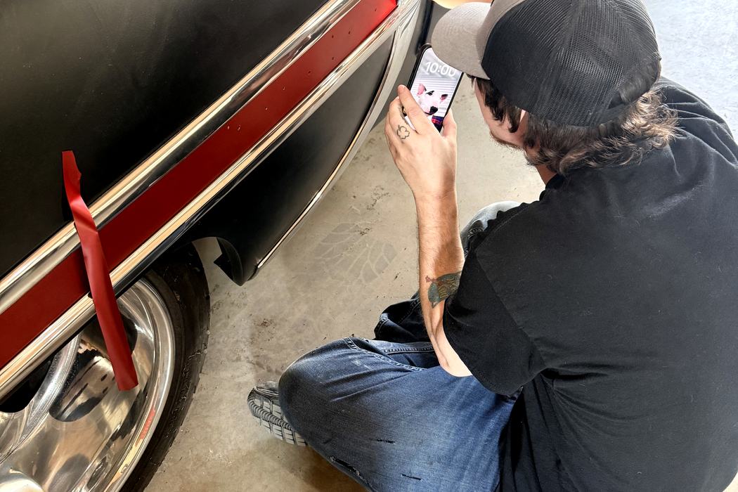 Applying the red spear insert to the Bel Air quarter panel by hand.