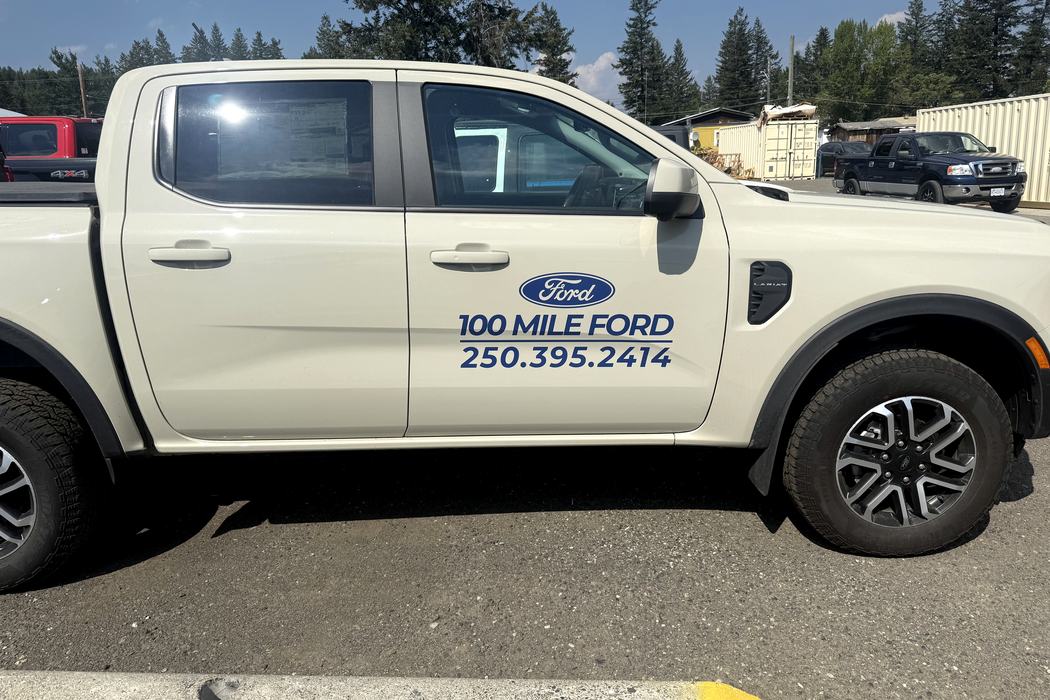 Ford F-150 door decal detail, dealership name and phone number.
