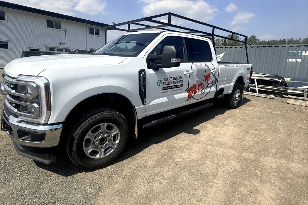 Ford Super Duty carrying Mr. T Contracting door graphics and bed lettering.
