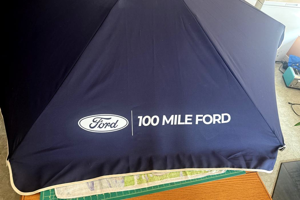 Close view of the 100 Mile Ford logo applied to an umbrella panel.