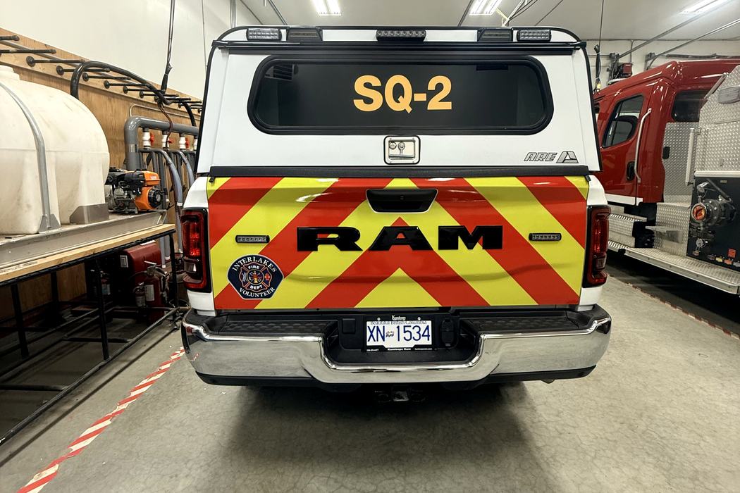 Rear of SQ-2 with red and yellow chevron tailgate and unit number on the glass.