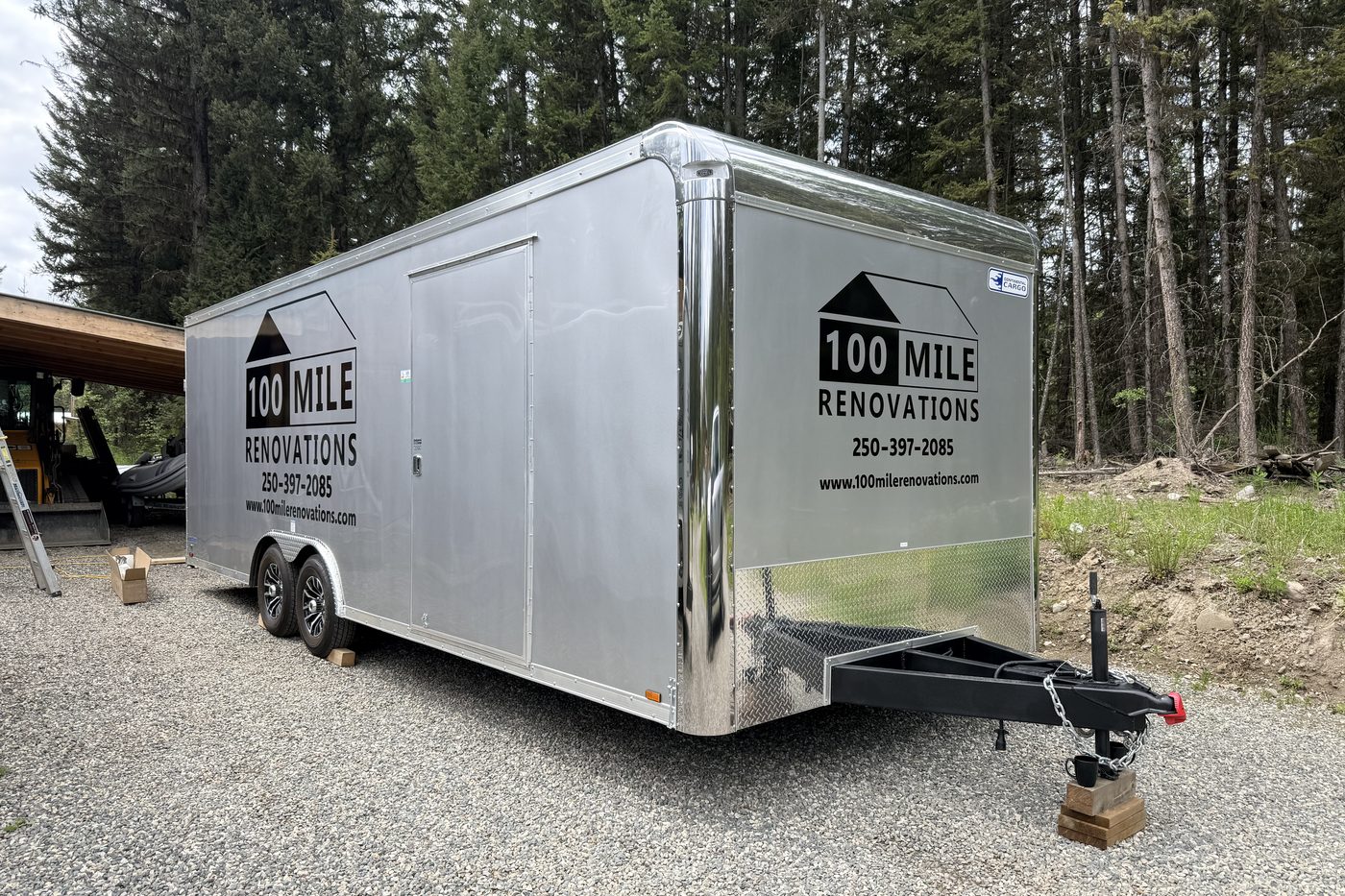 Enclosed cargo trailer carrying cut vinyl graphics for 100 Mile Renovations.