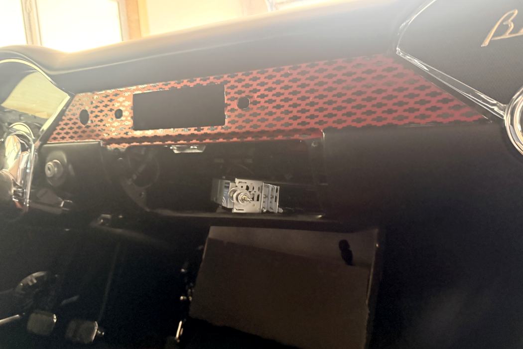 Patterned red and black vinyl applied to the Bel Air dash panel.