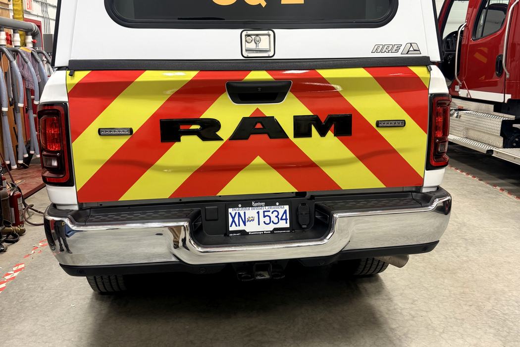 Three-quarter rear of SQ-2 showing INTERLAKES and FIRE RESCUE lettering on the canopy.