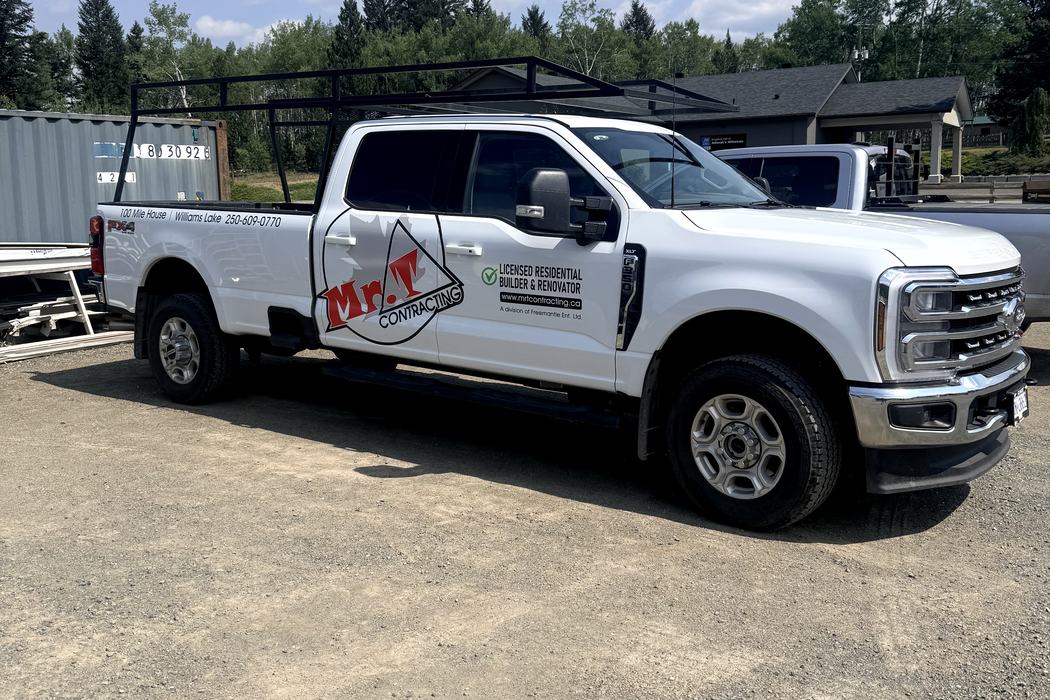 Side view of the Mr. T Contracting Super Duty with door crest and bed lettering.