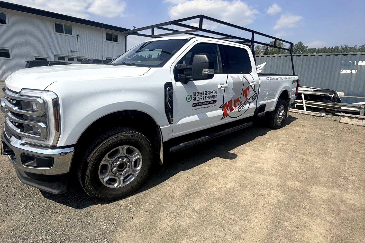 Ford Super Duty carrying Mr. T Contracting door graphics and bed lettering.